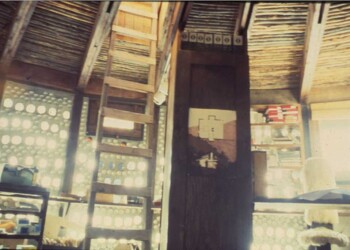 My first office in Cañon. It was here I learned to “orbit” garbage and found its true value. The wall in the back left is pickle jars and aluminum cans filled with water to form thermal mass bricks for structure and heat storage and… the passage of light.